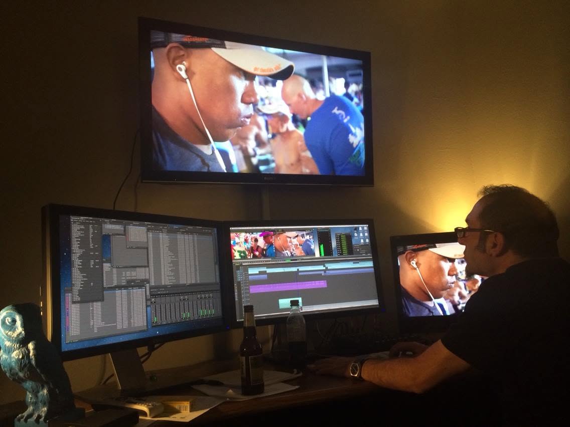 An editor cutting IRONMAN footage across a multi-monitor edit suite