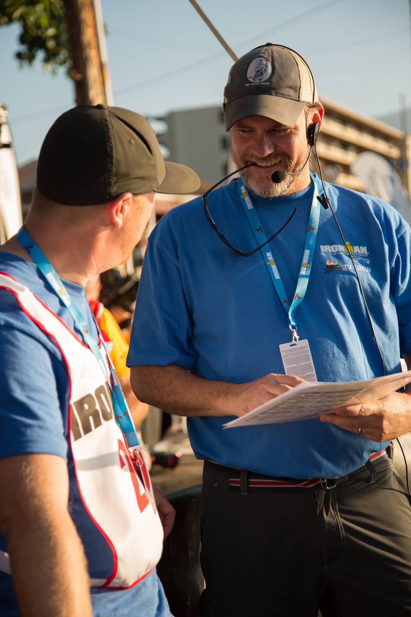Eric on headset reviewing a production rundown with a crew member on race morning